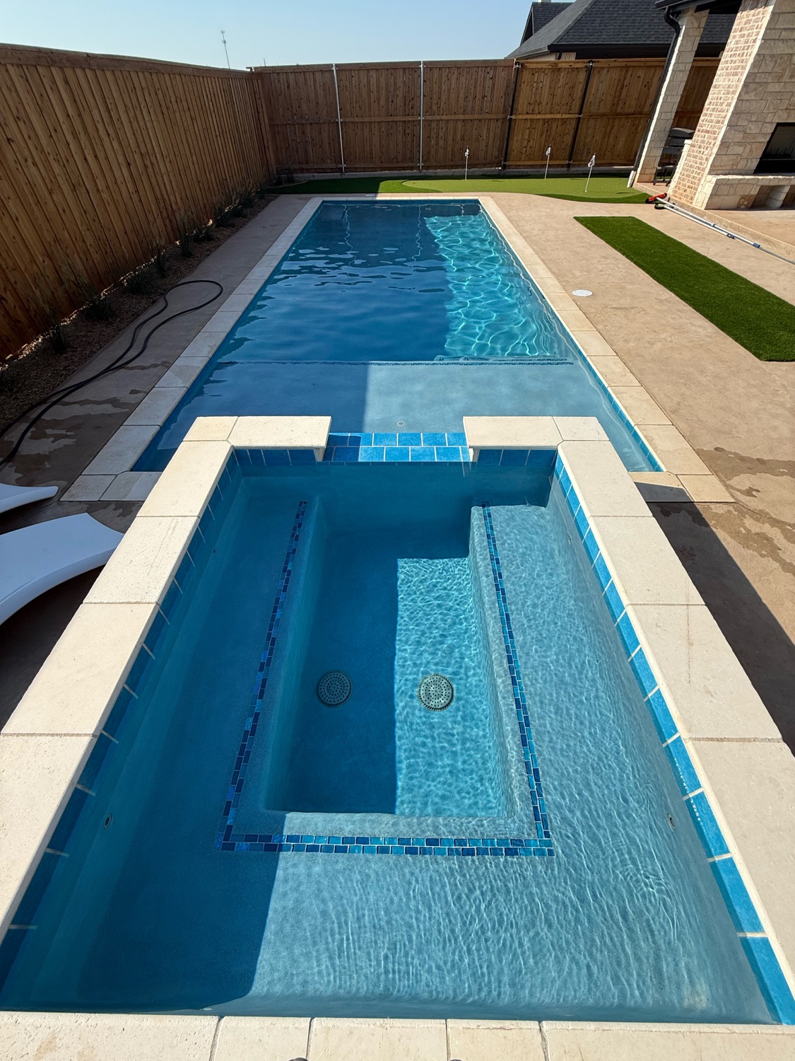 Finished geometric pool and spa with blue porcelain tile